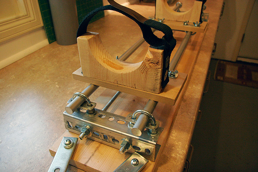 Multi-purpose rocket airframe bench. Built from off-the-shelf accessories, the base <br />is assembled from angle-iron cut to size and then bolted together with 3/8" <br />all-thread. This holds the angle-iron firmly together, which is in turn <br />fastened to a piece of pine, making the unit portable.