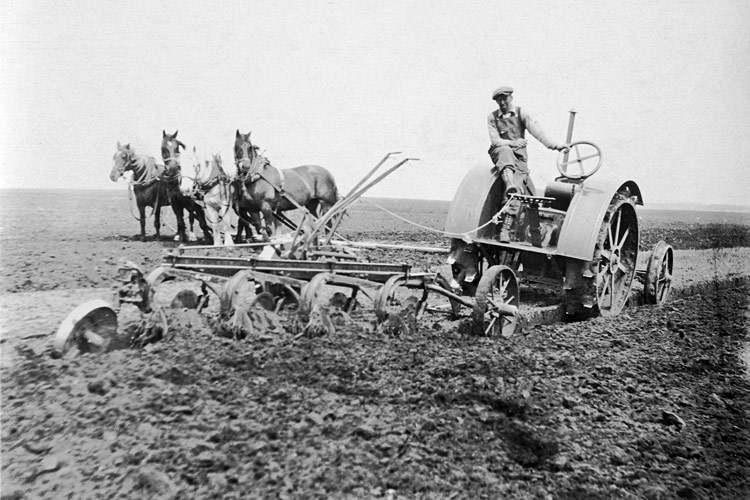 A remarkable photo of Thomas H. Walker (Tammy) on tractor, taking a break <br />from a day of plowing, near Pilot Mound, Manitoba. c.1935